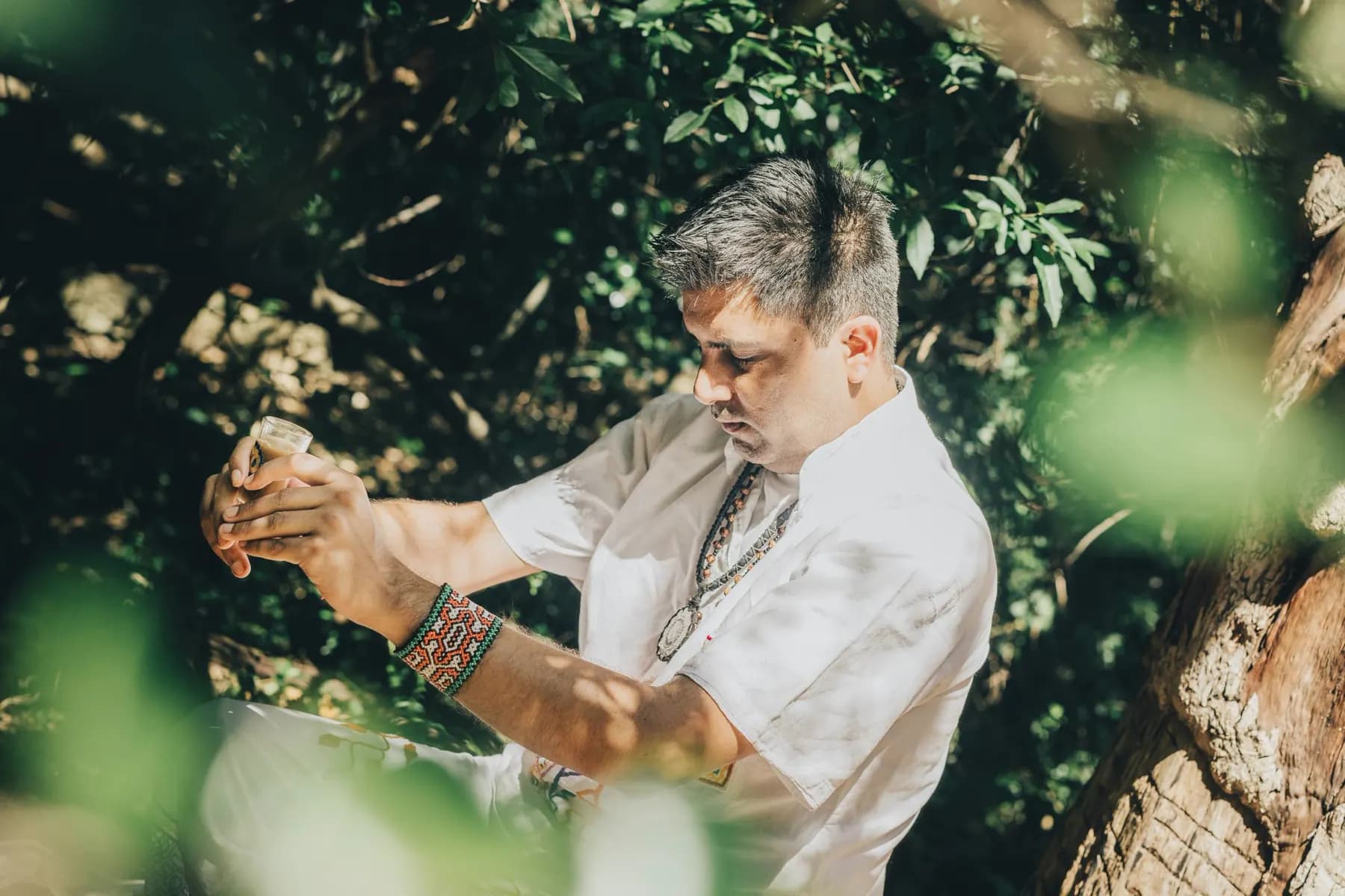 Jayesh Mitha preparing a plant medicine ceremony among the trees in Cape Town