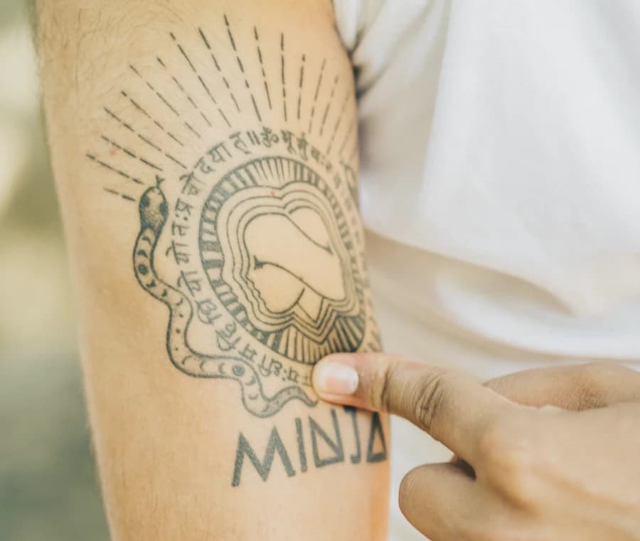 The MINJAY emblem tattooed on Jayesh Mitha’s arm — a tribute to his brother Minesh